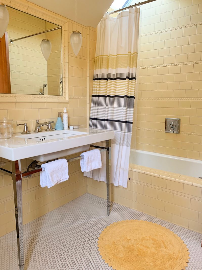 Bathroom with yellow subway tile and skylight